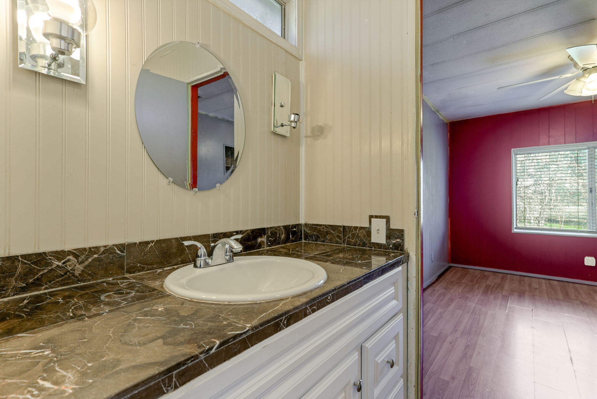 5082 Happy Valley Road Anderson, CA 96007 - Photo 22 of 66 a bathroom with a granite countertop sink and a mirror