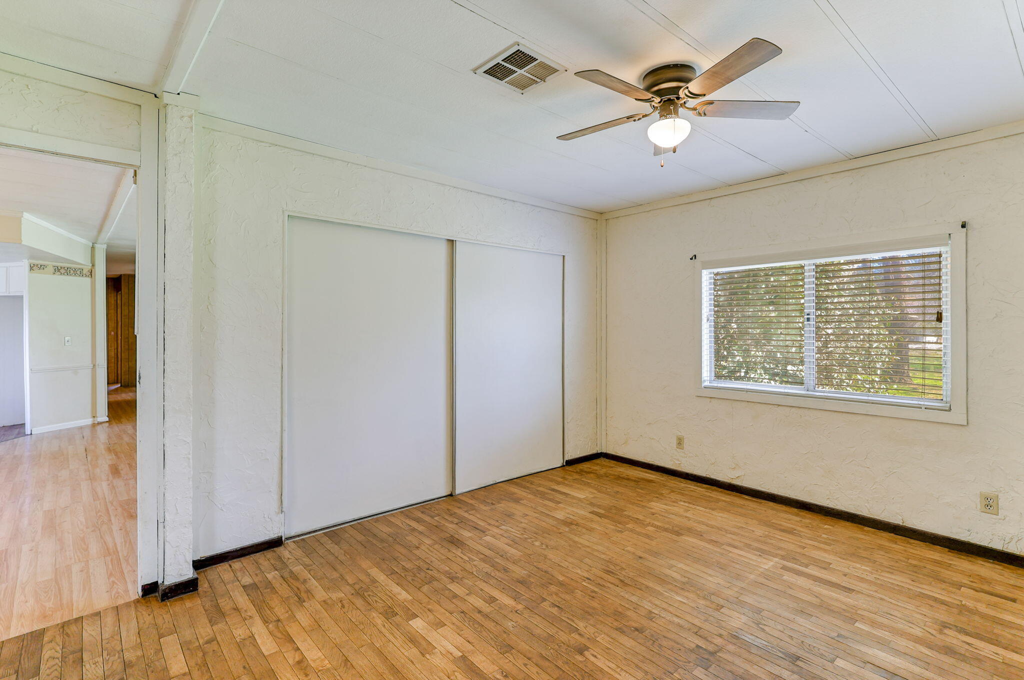 5082 Happy Valley Road Anderson, CA 96007 - Photo 26 of 66 wooden floor in an empty room with a window