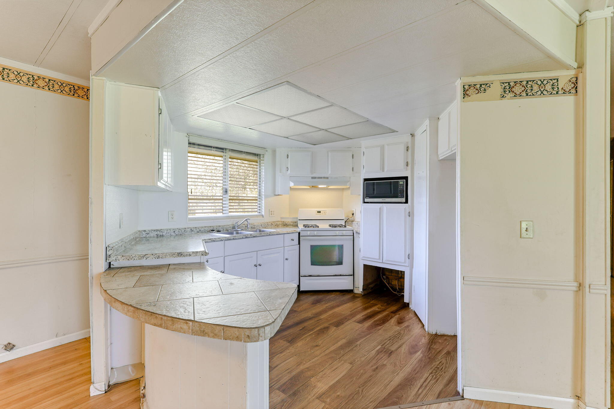 5082 Happy Valley Road Anderson, CA 96007 - Photo 27 of 66 a kitchen with stainless steel appliances granite countertop a sink refrigerator and cabinets