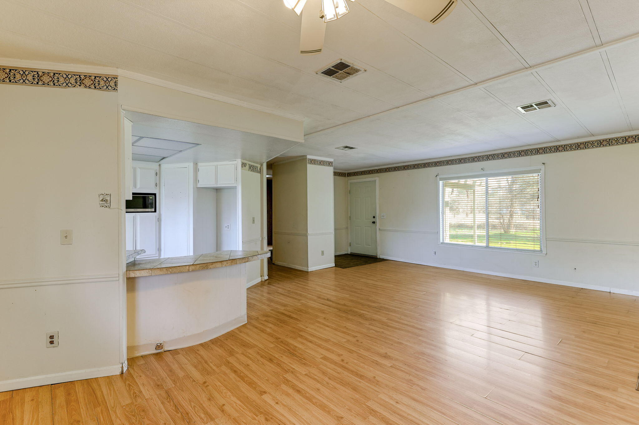 5082 Happy Valley Road Anderson, CA 96007 - Photo 28 of 66 a view of empty room with wooden floor and fan