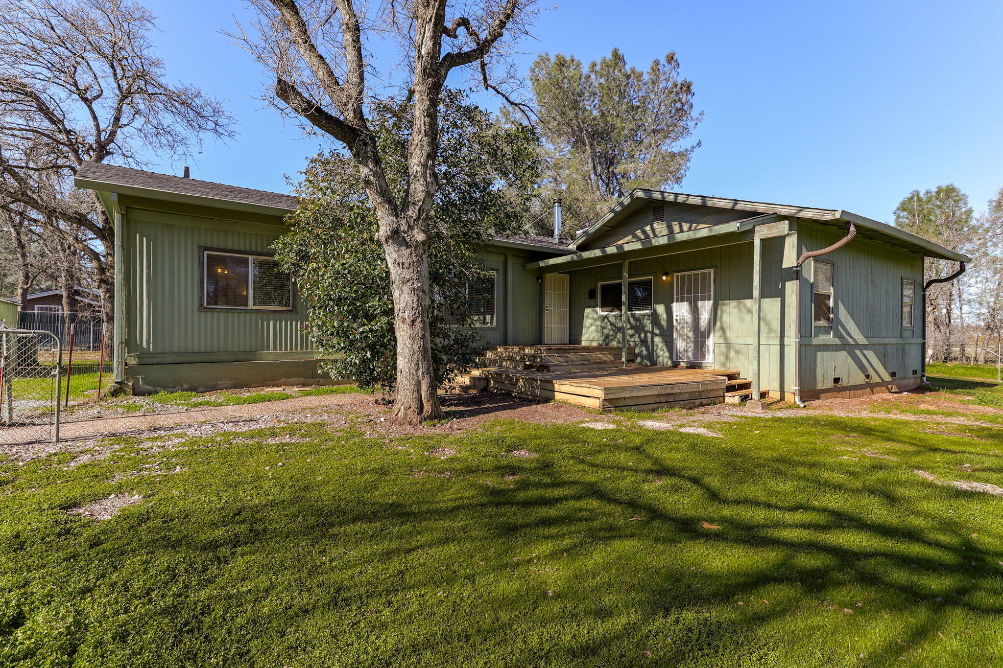5082 Happy Valley Road Anderson, CA 96007 - Photo 31 of 66 a view of a house with backyard and a tree