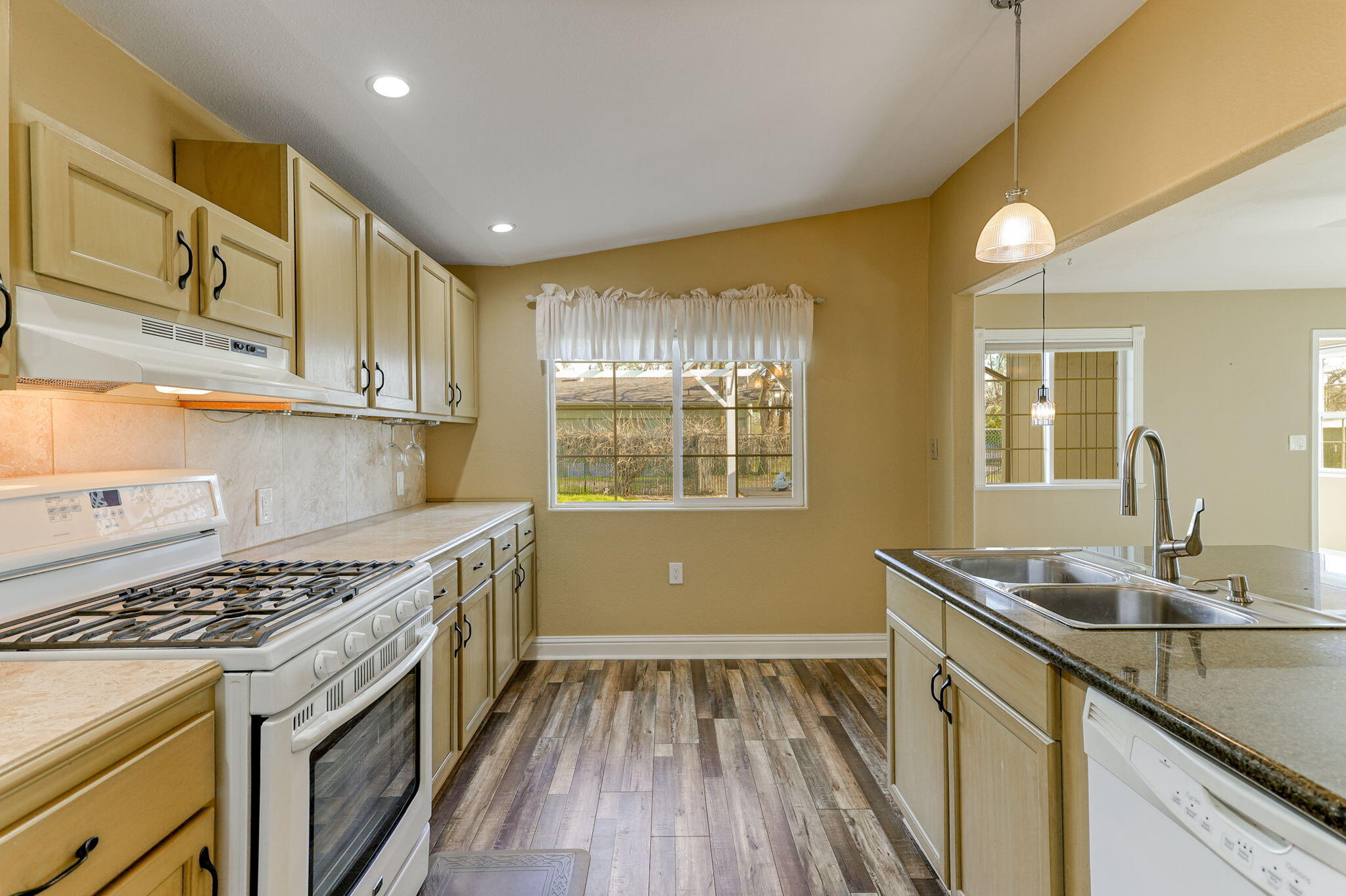 5082 Happy Valley Road Anderson, CA 96007 - Photo 35 of 66 a kitchen that has a sink wooden floor stainless steel appliances and cabinets