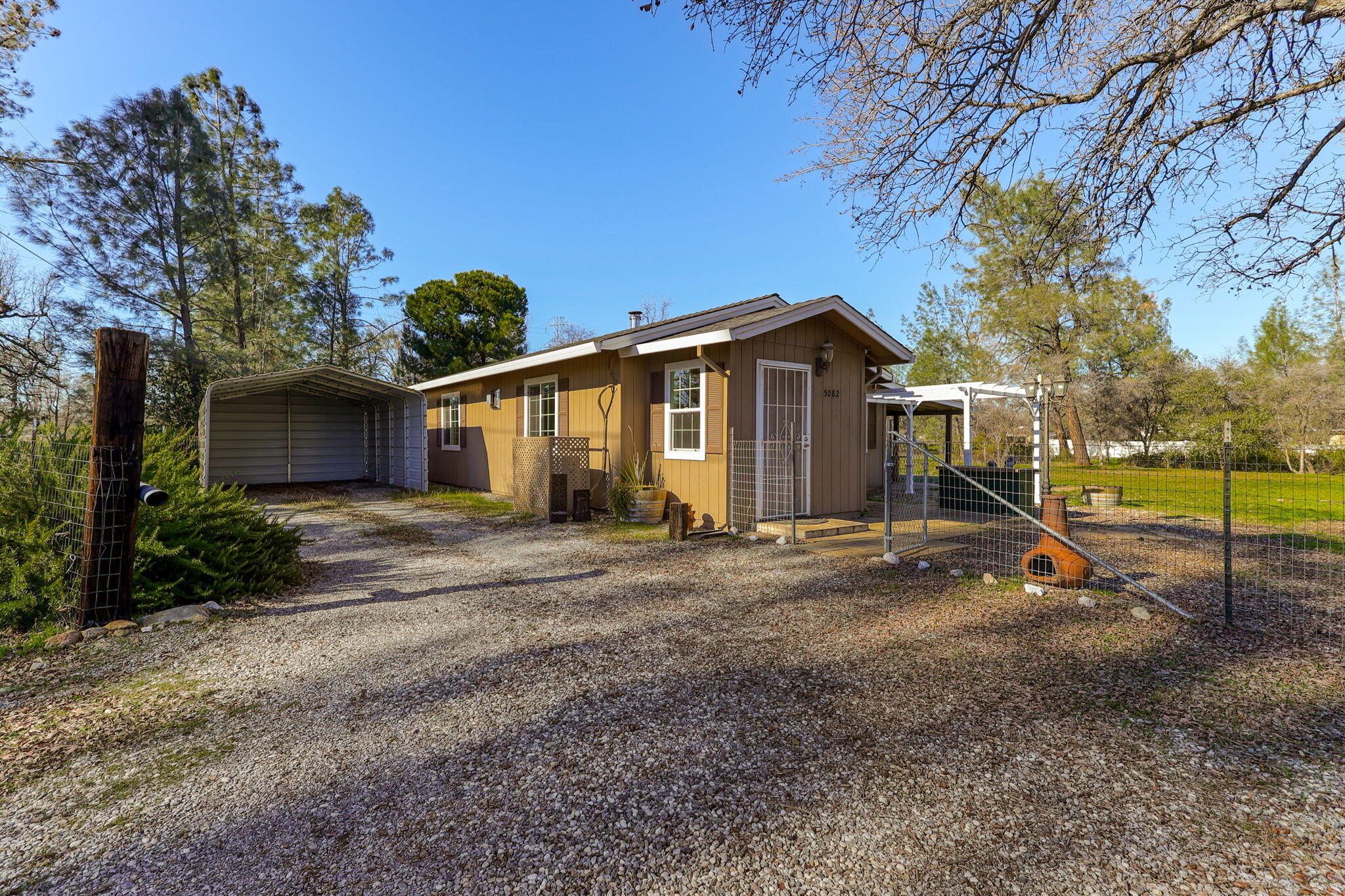 5082 Happy Valley Road Anderson, CA 96007 - Photo 38 of 66 a view of a house with backyard and a tree