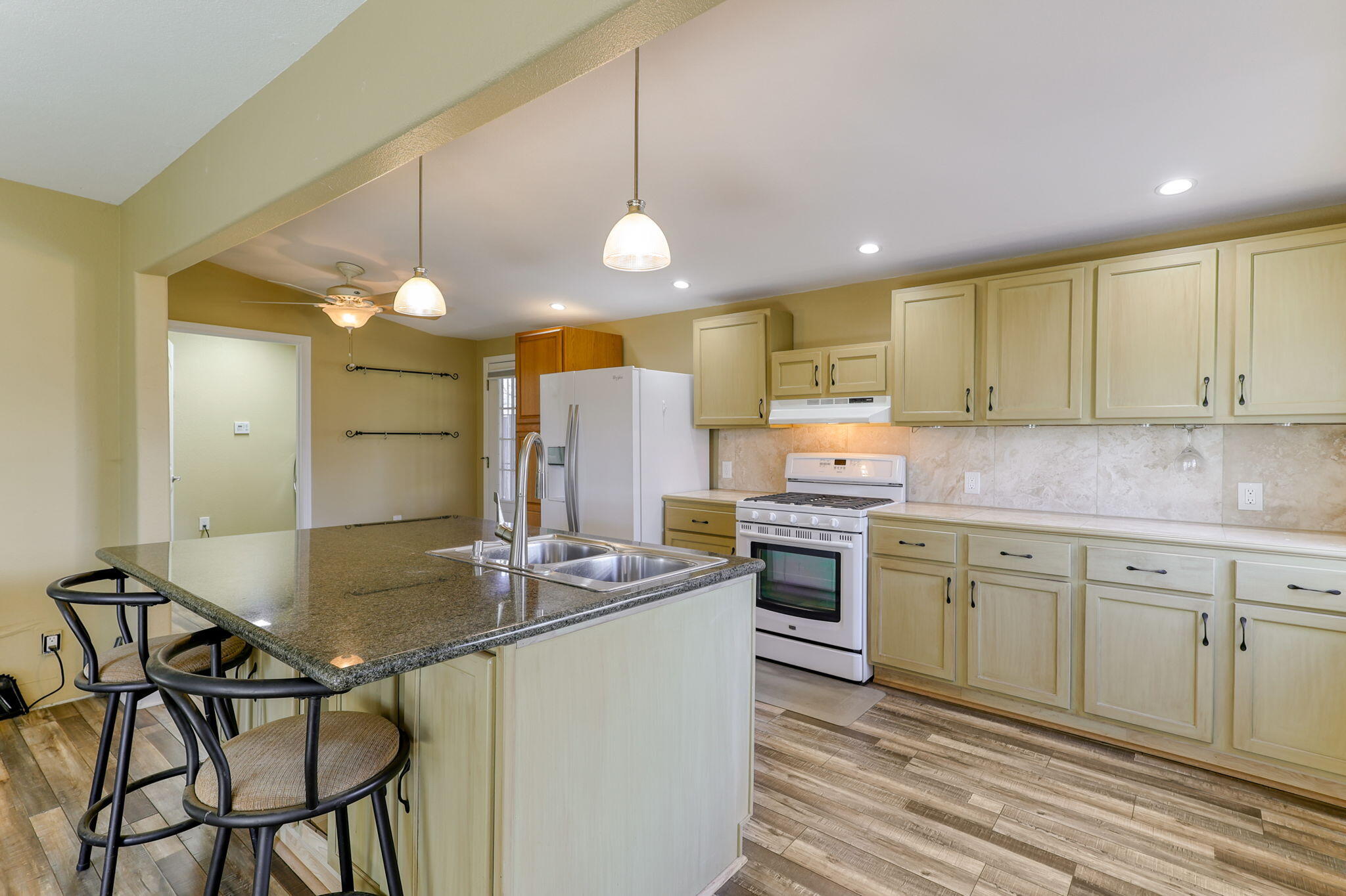 5082 Happy Valley Road Anderson, CA 96007 - Photo 48 of 66 a kitchen with kitchen island granite countertop a sink cabinets and stainless steel appliances