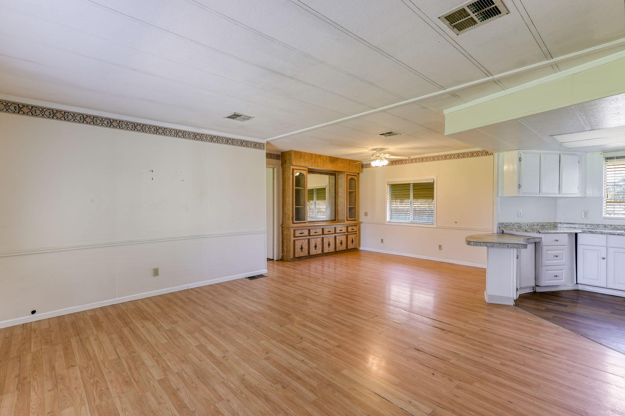 5082 Happy Valley Road Anderson, CA 96007 - Photo 5 of 66 a view of a kitchen with wooden floor and a window
