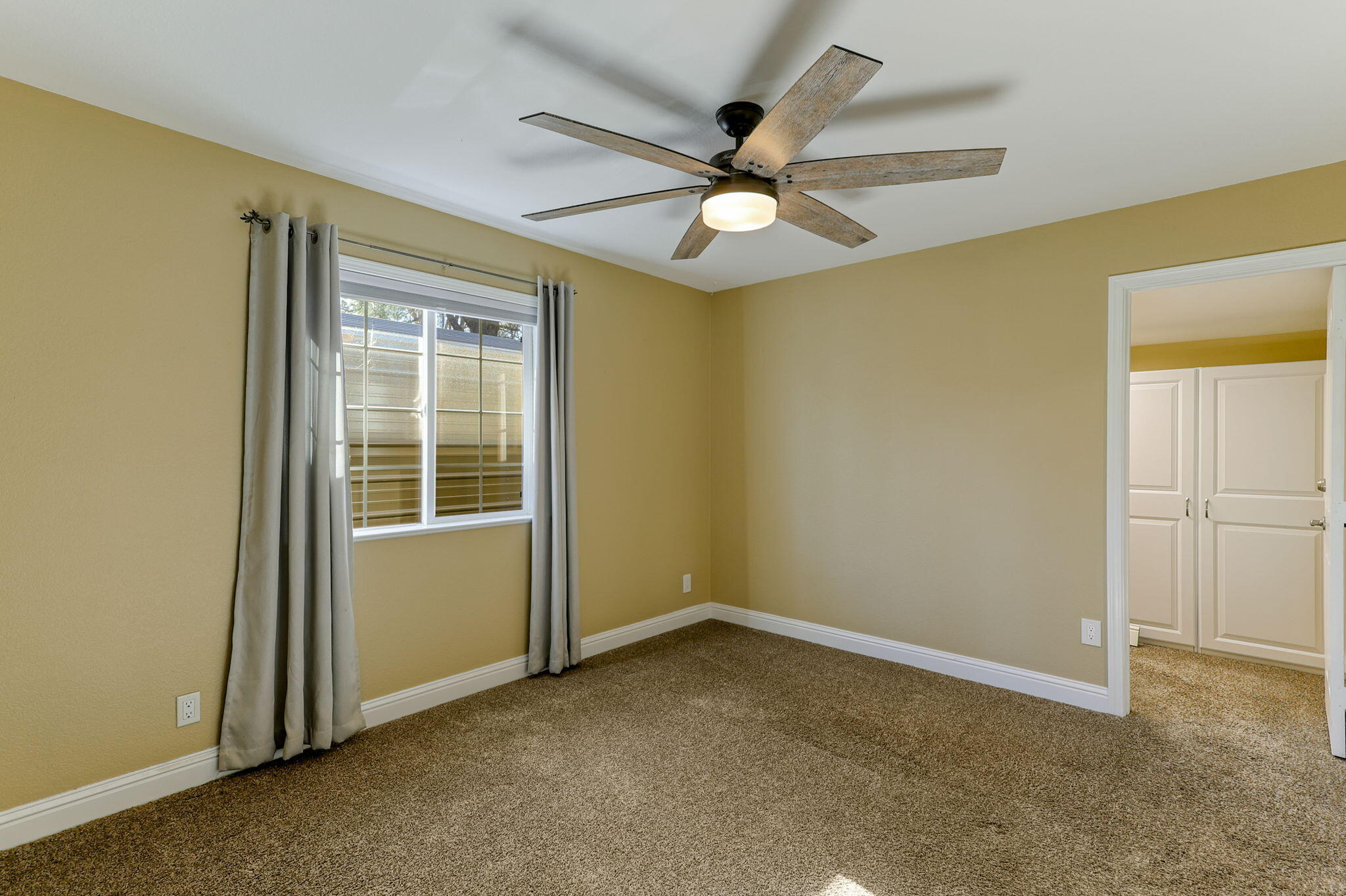 5082 Happy Valley Road Anderson, CA 96007 - Photo 52 of 66 an empty room with windows and fan