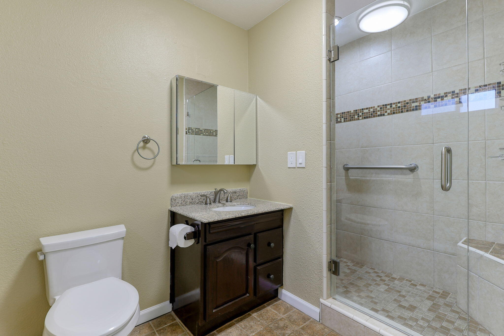 5082 Happy Valley Road Anderson, CA 96007 - Photo 57 of 66 a bathroom with a granite countertop toilet sink and shower
