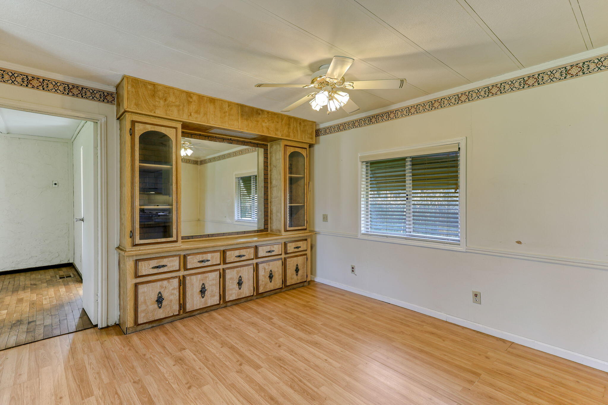 5082 Happy Valley Road Anderson, CA 96007 - Photo 6 of 66 a view of a livingroom with a chandelier fan and wooden floor