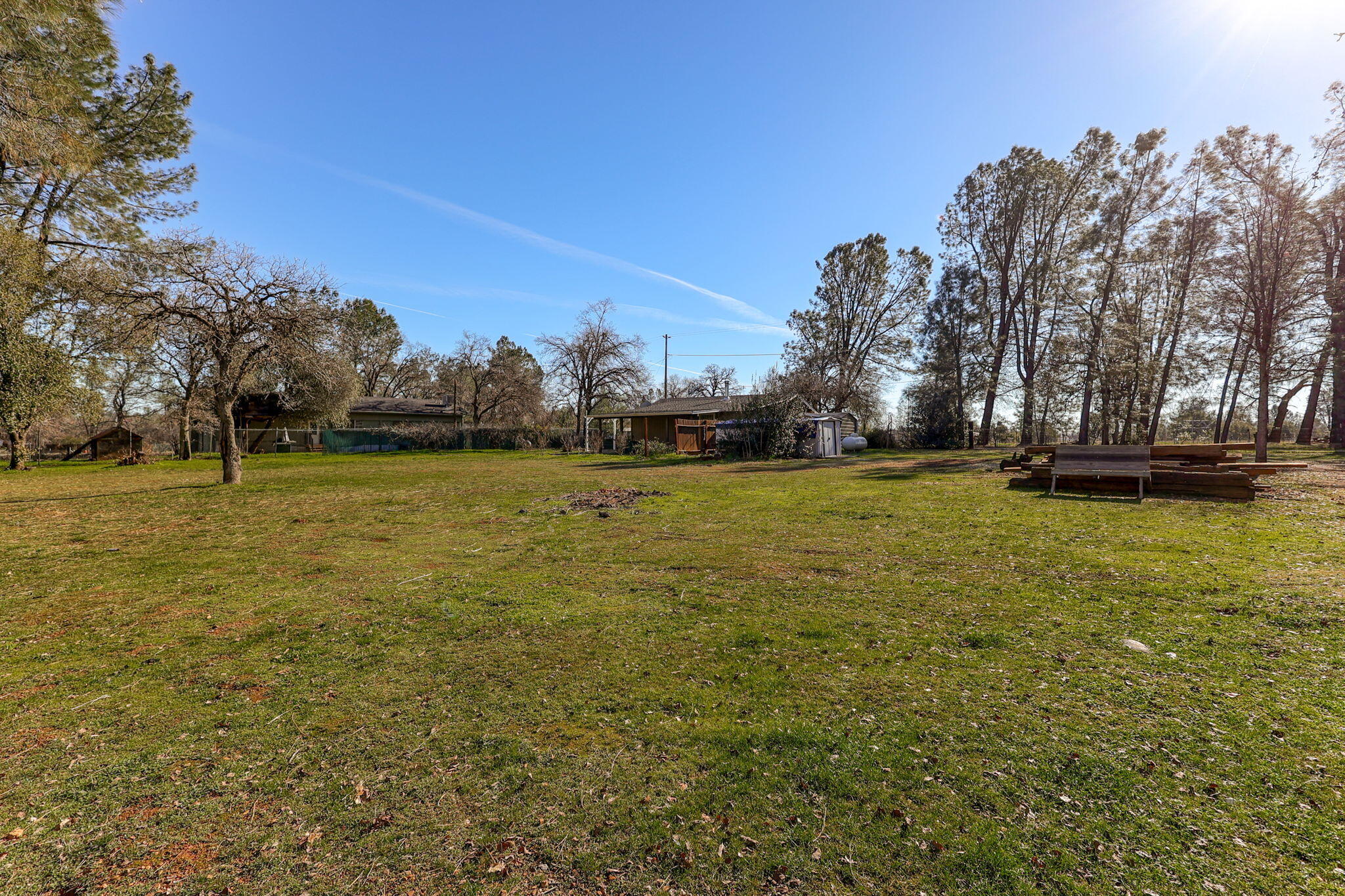 5082 Happy Valley Road Anderson, CA 96007 - Photo 61 of 66 a view of a yard with a house in the background