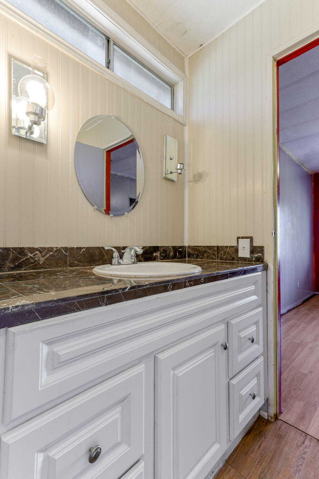 5082 Happy Valley Road Anderson, CA 96007 - Photo 9 of 66 a bathroom with a granite countertop sink and a mirror