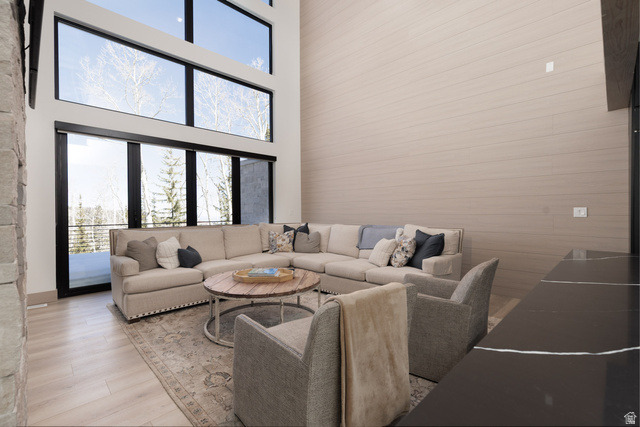 160 Ridgeview Street, Unit 7B Brian Head, UT 84719 - Photo 7 of 40 Living room featuring healthy amount of natural light, a high ceiling, and wood finished floors