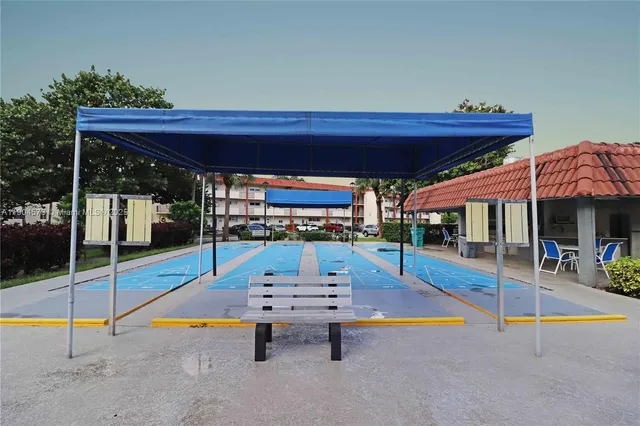 an outdoor space with swimming pool and furniture