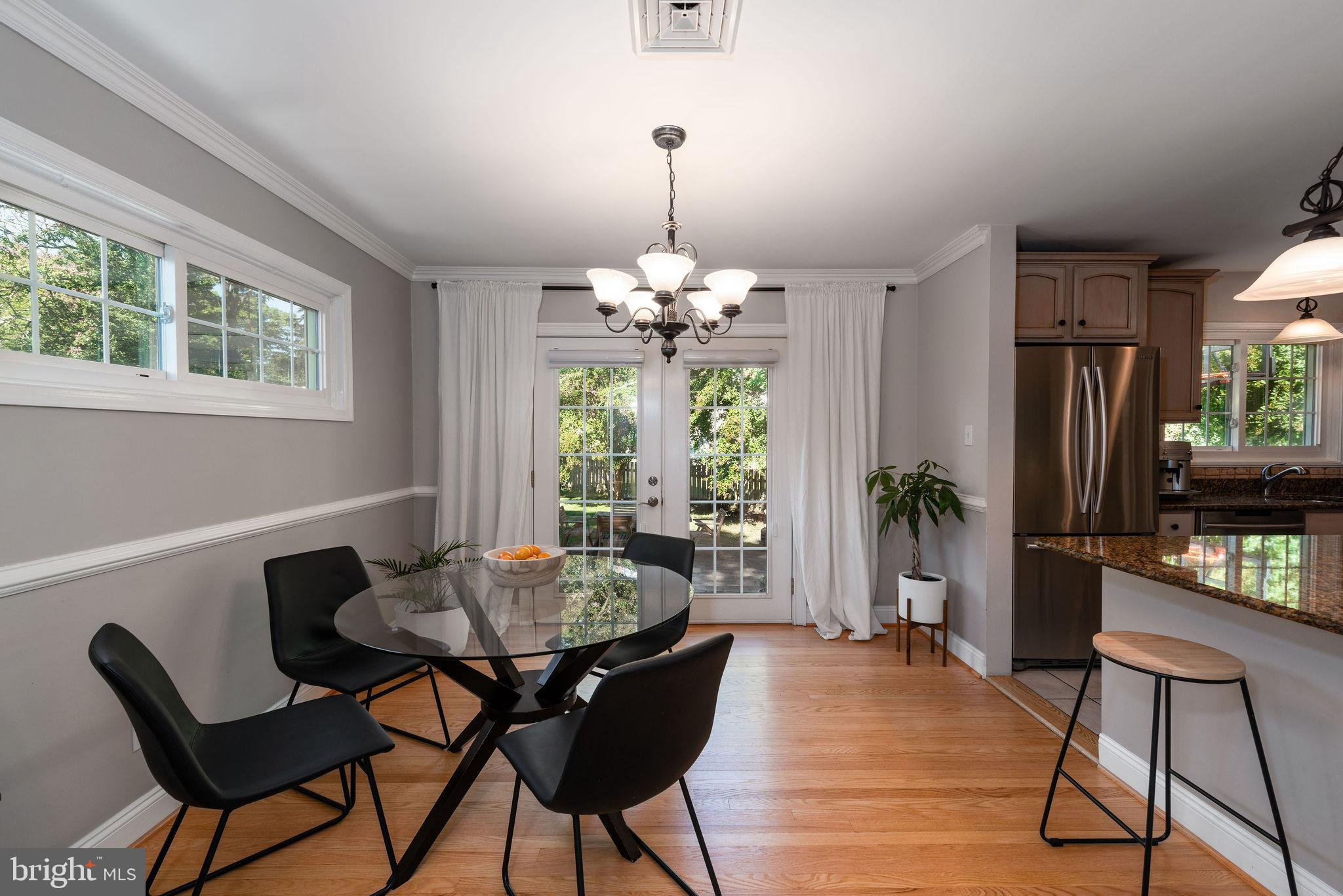 9 Beach Road Severna Park, MD 21146 - Photo 19 of 58 a dining room with furniture a chandelier and wooden floor