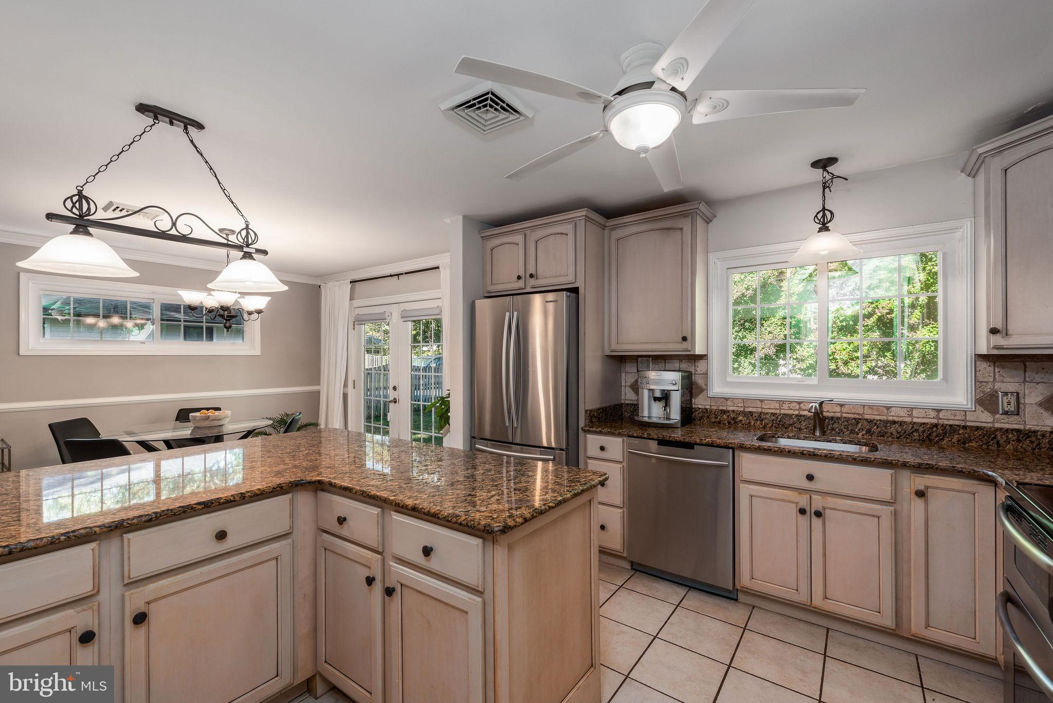 9 Beach Road Severna Park, MD 21146 - Photo 22 of 58 a kitchen with granite countertop stainless steel appliances a sink stove and refrigerator
