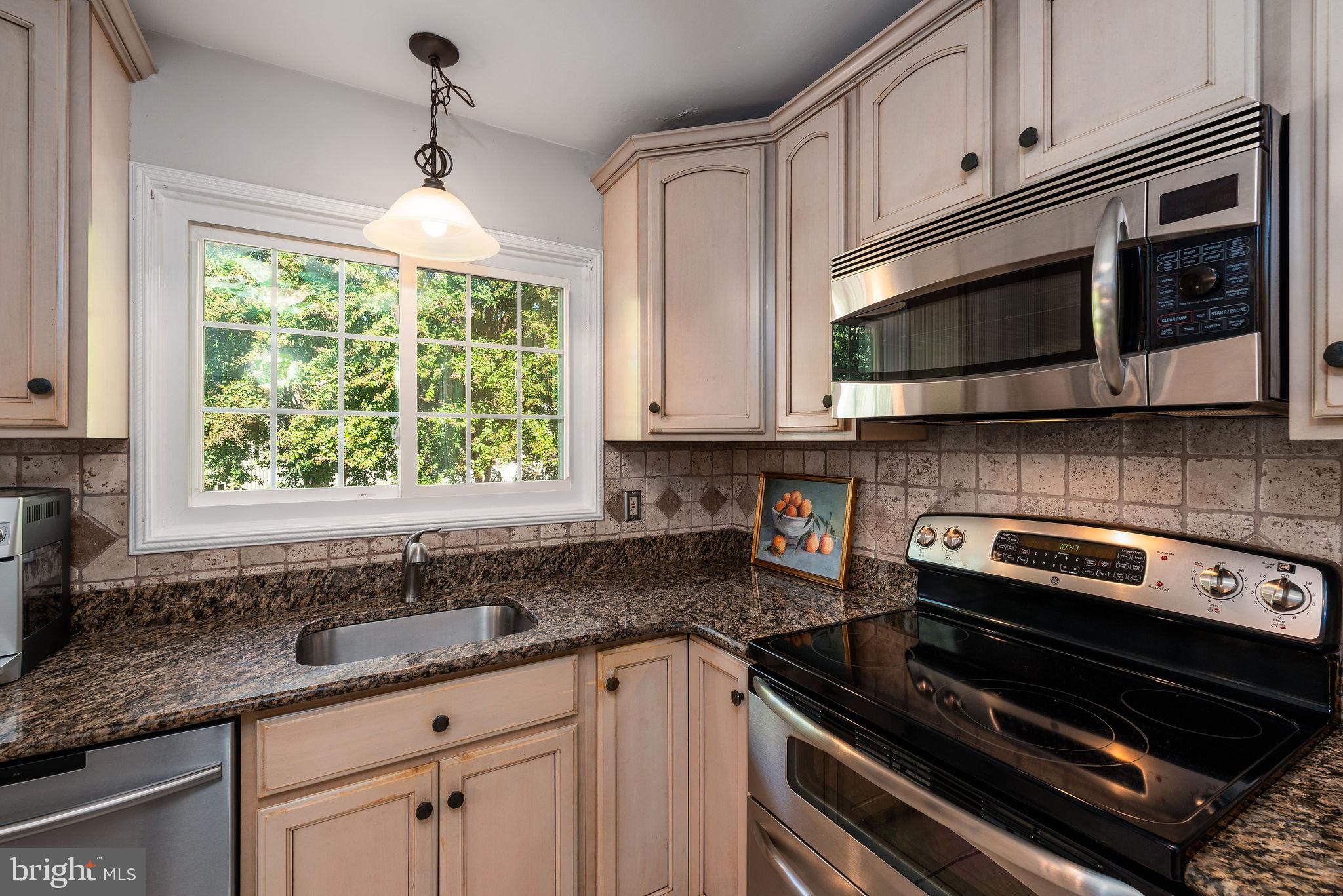 9 Beach Road Severna Park, MD 21146 - Photo 23 of 58 a kitchen with granite countertop a stove microwave and sink