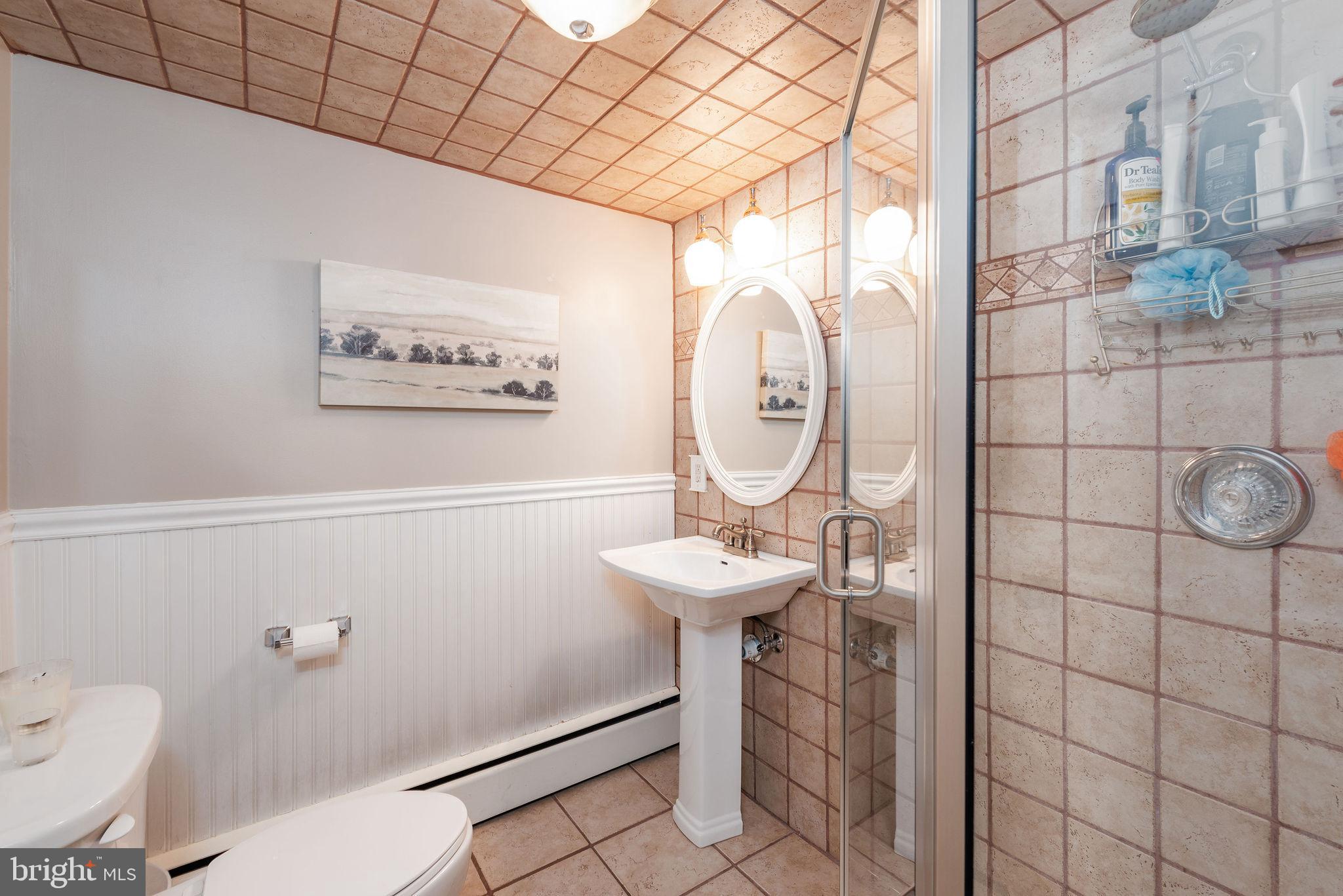9 Beach Road Severna Park, MD 21146 - Photo 26 of 58 a bathroom with a sink toilet and shower