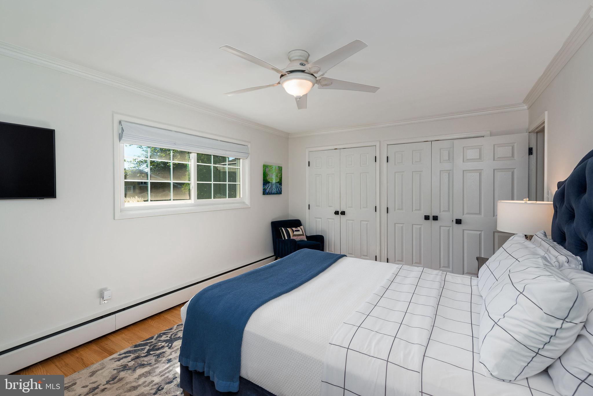 9 Beach Road Severna Park, MD 21146 - Photo 39 of 58 a bedroom with a large bed and a tv