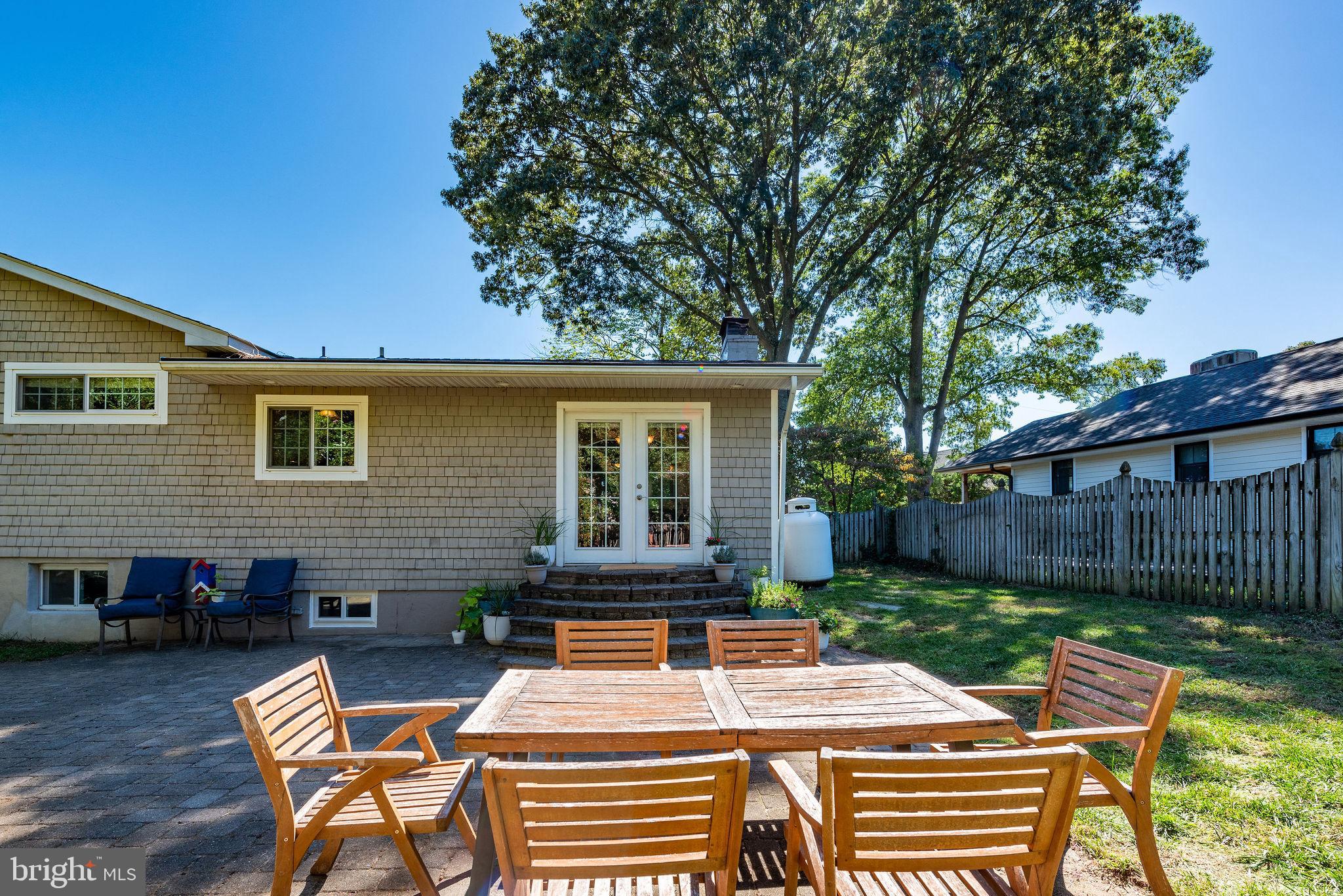 9 Beach Road Severna Park, MD 21146 - Photo 51 of 58 a view of a patio with table and chairs with wooden fence and plants