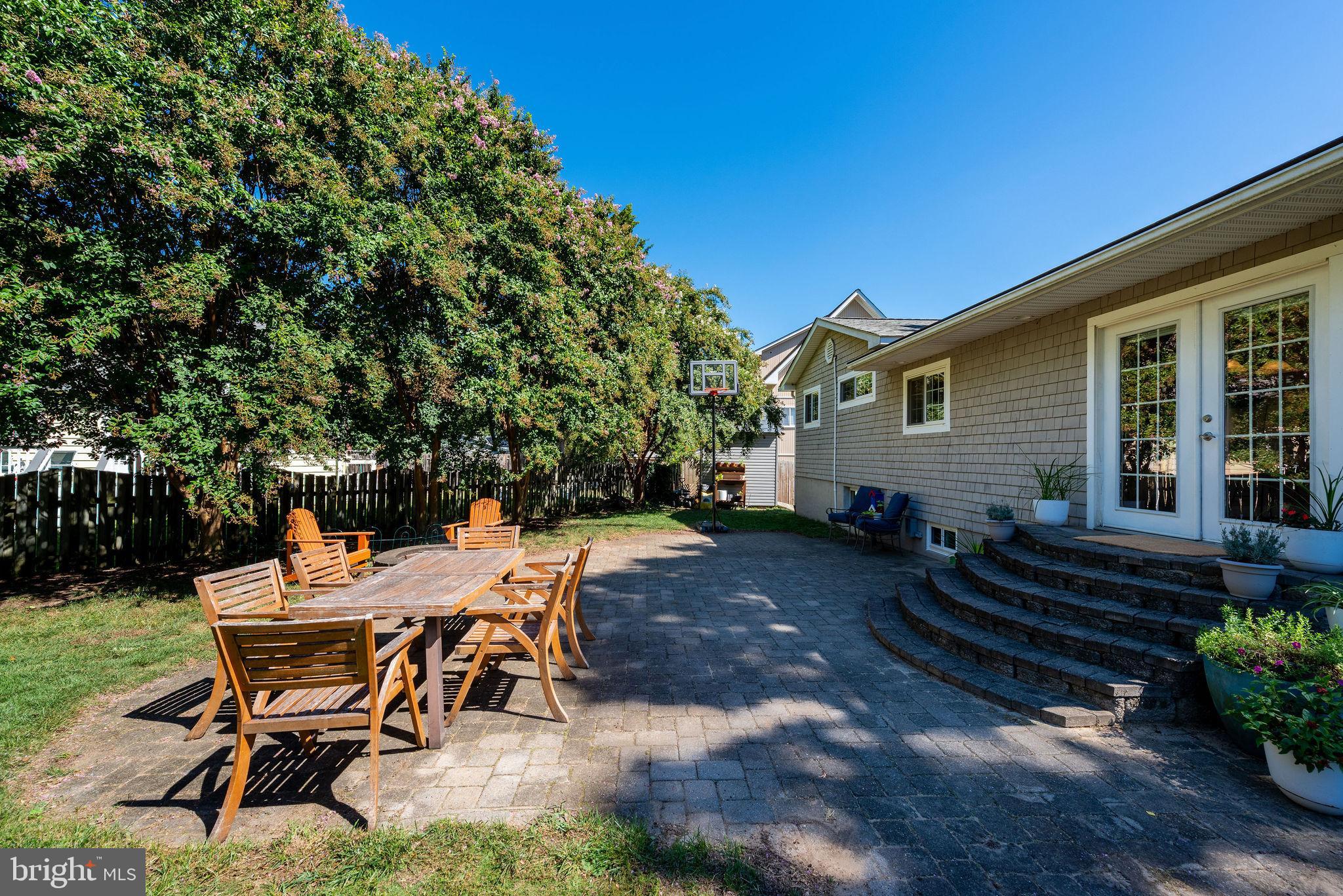 9 Beach Road Severna Park, MD 21146 - Photo 52 of 58 a view of a backyard with table and chairs and potted plants