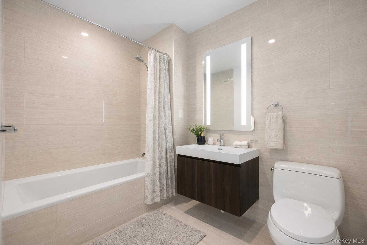 131-05 40 Road, Unit 18H Queens, NY 11354 - Photo 14 of 14 a bathroom with a sink a toilet and shower