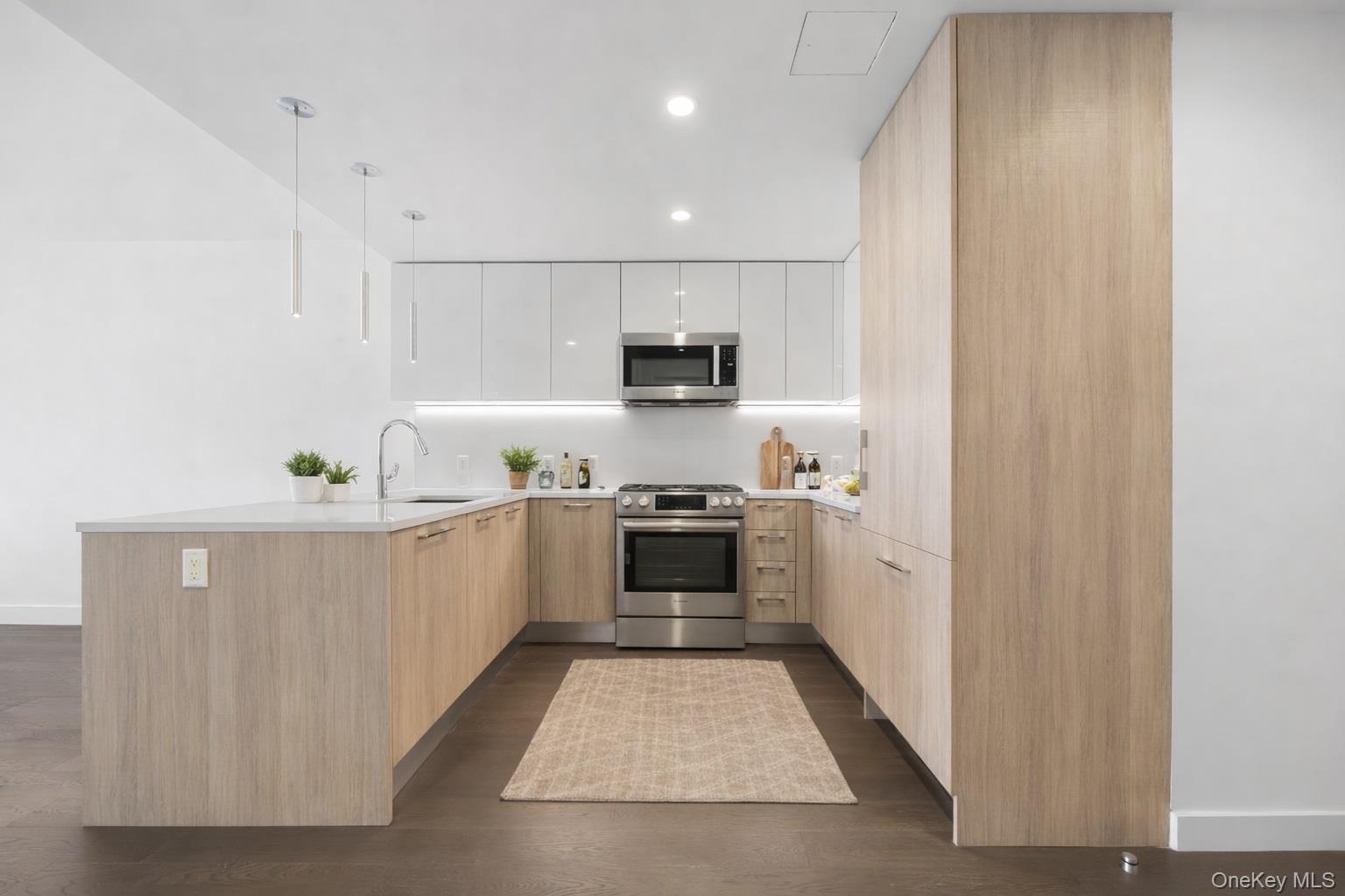 131-05 40 Road, Unit 18H Queens, NY 11354 - Photo 7 of 14 a kitchen with a sink and a stove top oven