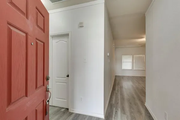 a view of a hallway with wooden floor
