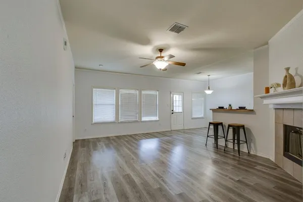 wooden floor in an empty room with a window
