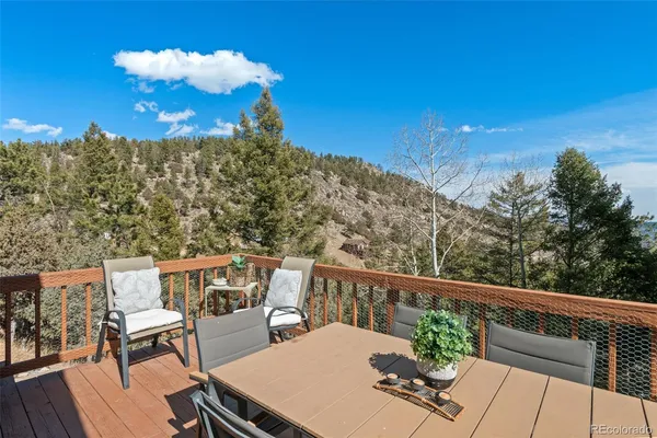 a view of a chairs and table on the roof deck