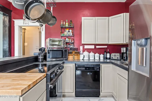 a kitchen with granite countertop a stove a oven and a sink
