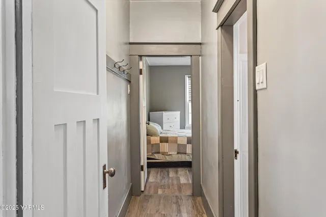 a bedroom with a bed and closet with wooden floor
