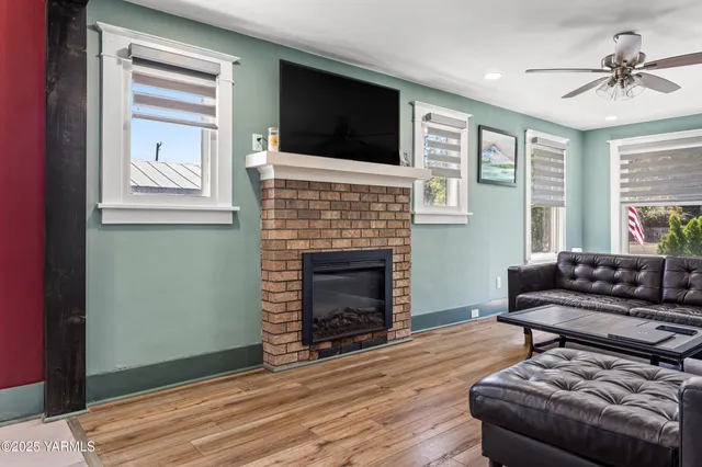 a living room with furniture a fireplace and a flat screen tv