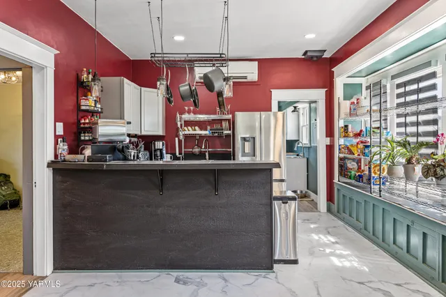 a kitchen with stainless steel appliances kitchen island granite countertop a refrigerator and a stove