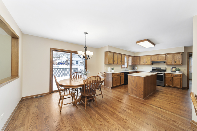 1940 Slippery Rock Road Naperville, IL 60565 - Photo 11 of 28 a kitchen with a table chairs and a wooden floor