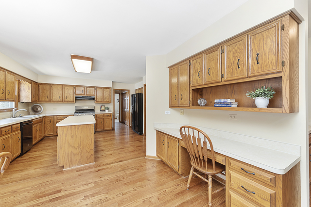 1940 Slippery Rock Road Naperville, IL 60565 - Photo 12 of 28 a kitchen with stainless steel appliances granite countertop a refrigerator a stove top oven and a sink with granite countertops