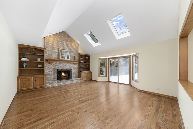 1940 Slippery Rock Road Naperville, IL 60565 - Photo 8 of 28 a view of an empty room with wooden floor fireplace and a window