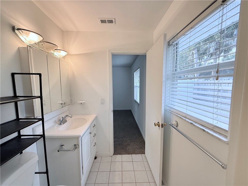 224 Georgia Street Vero Beach, FL 32962 - Photo 15 of 23 a bathroom with a sink a toilet and shower