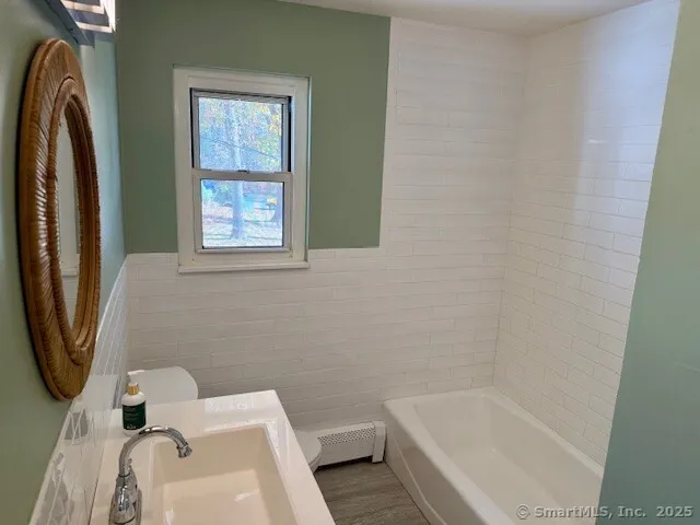 a bathroom with a sink toilet and bathtub