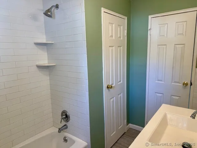 a bathroom with a tub and shower