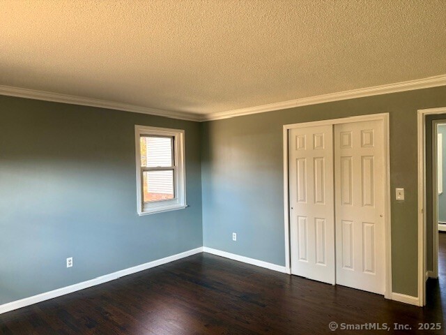 498 Oak Avenue, Unit 28 Cheshire, CT 06410 - Photo 15 of 21 a view of an empty room with wooden floor and a window