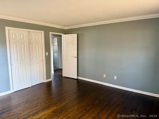 498 Oak Avenue, Unit 28 Cheshire, CT 06410 - Photo 16 of 21 a view of an empty room with wooden floor and a window