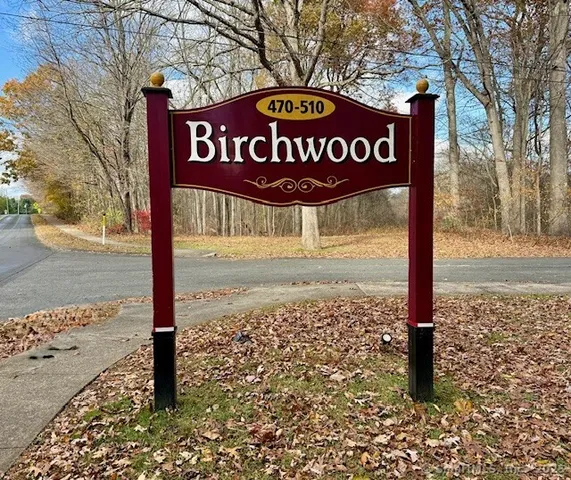 a street sign on a sidewalk next to a road