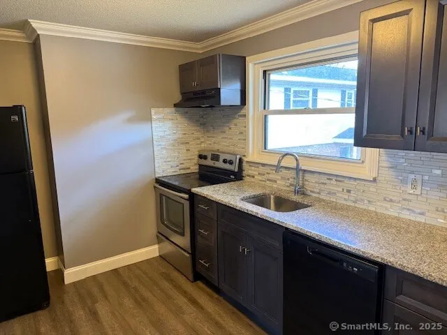 a kitchen with a sink and a refrigerator