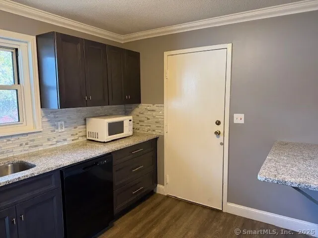 a kitchen with a sink and a wooden cabinets