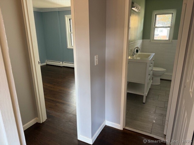 498 Oak Avenue, Unit 28 Cheshire, CT 06410 - Photo 10 of 21 a view of a hallway with wooden floor and a bathroom