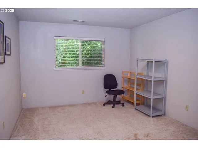 a view of room with workspace and a window