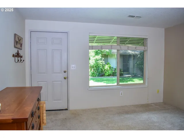 a view of backyard with wooden fence