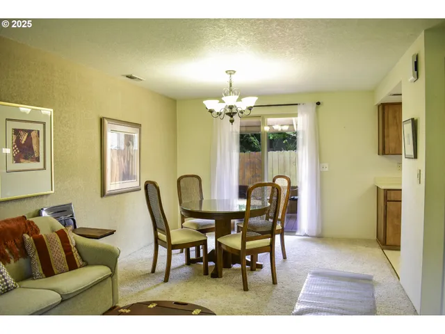 a dining room with furniture and chandelier