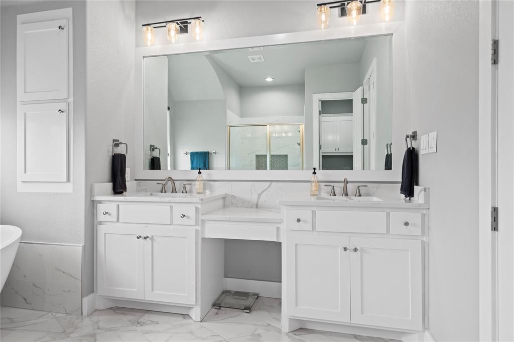 1024 Henry Way Springtown, TX 76082 - Photo 15 of 29 Dual vanity with individual sinks, white cabinetry, and a spacious countertop
