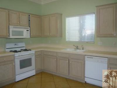 68433 Riviera Road Cathedral City, CA 92234 - Photo 4 of 21 a kitchen with granite countertop white cabinets and a stove