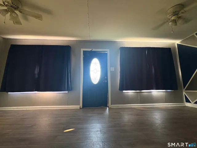 a view of empty room with wooden floor